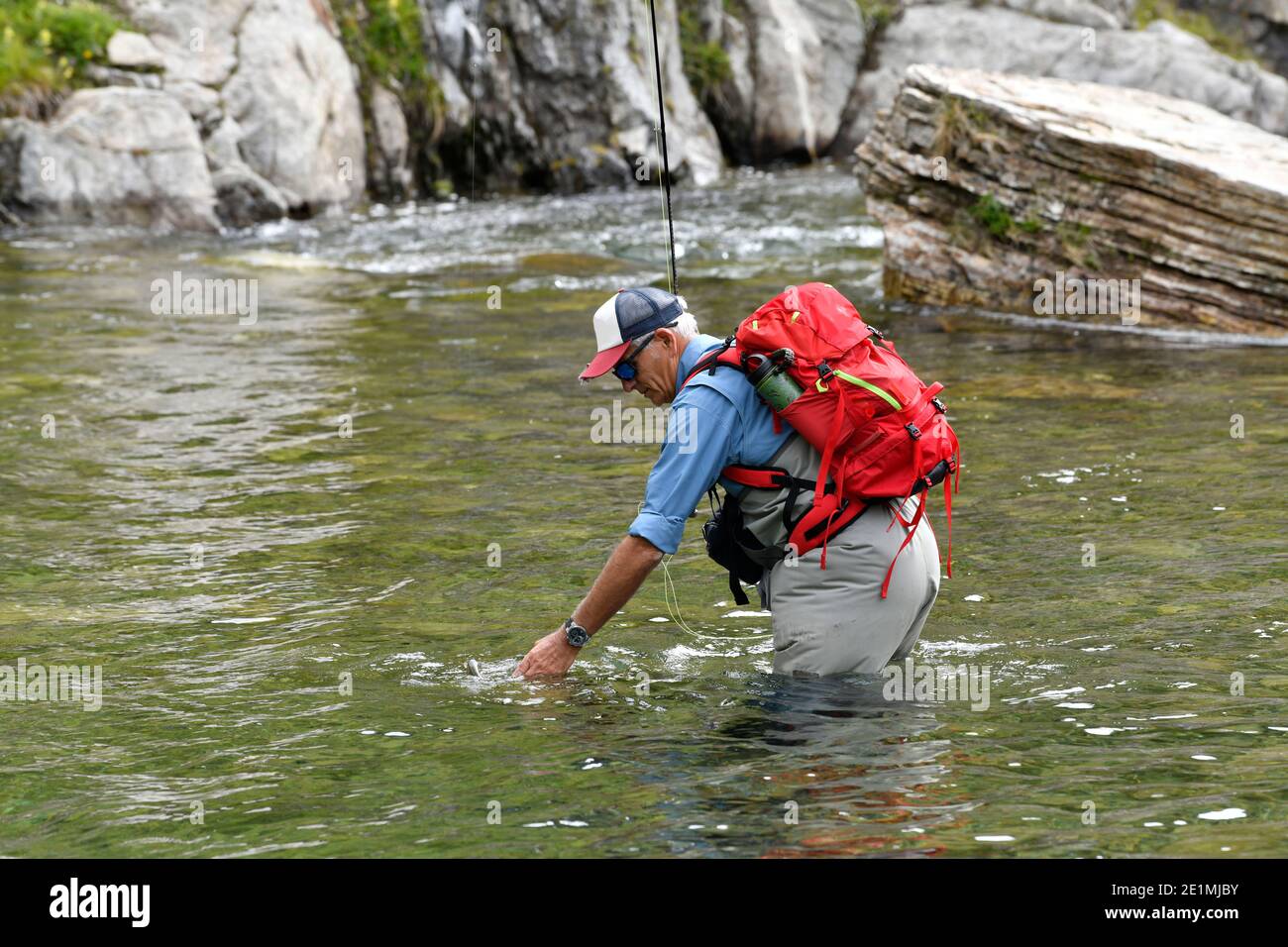 fly fisherman in the high mountains Stock Photo