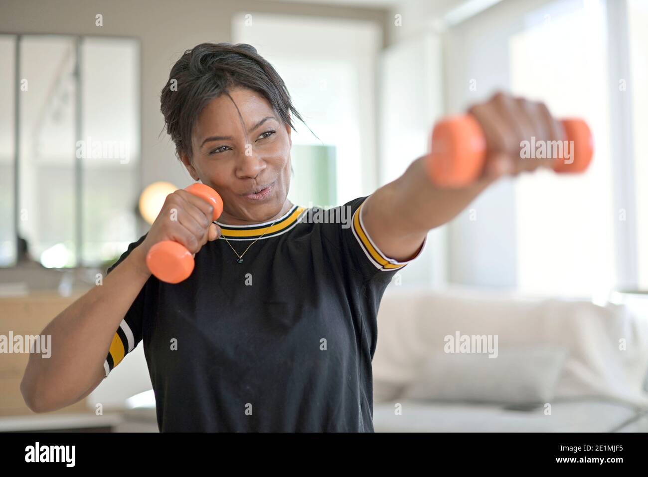 Athletic african-american woman doing fitness exercices at home Stock Photo