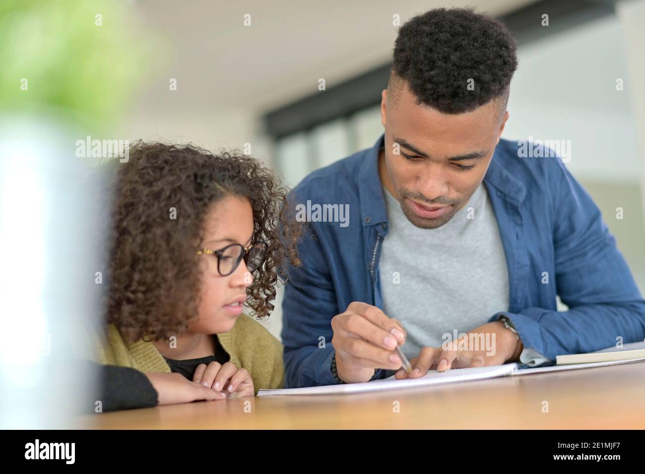 Daddy helping daughter with homework Stock Photo