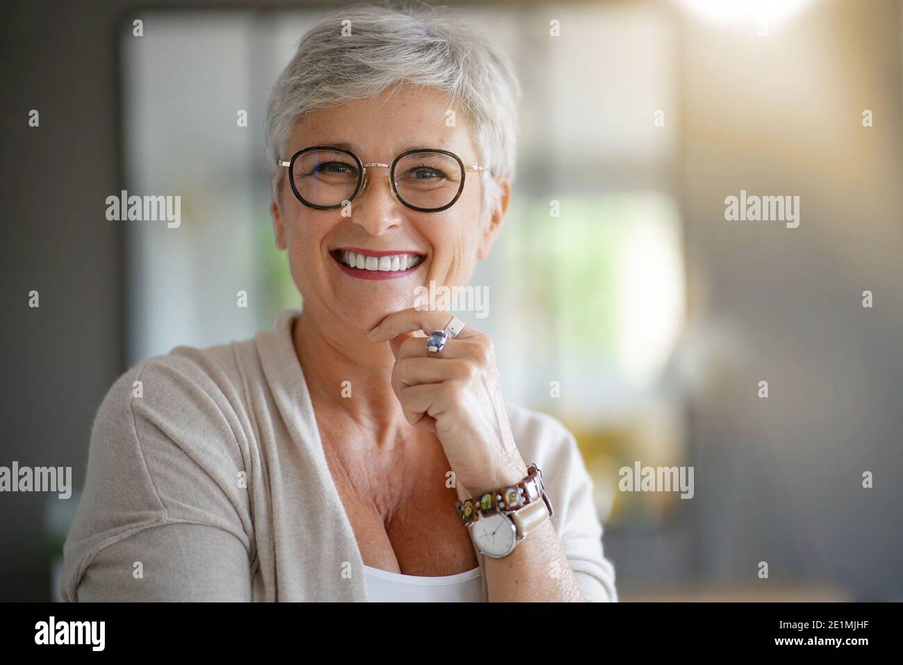 portrait of a beautiful smiling 55 year old woman with white hair Stock Photo