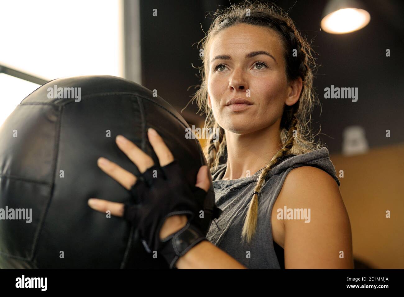Woman in a gym with a medicine ball Stock Photo