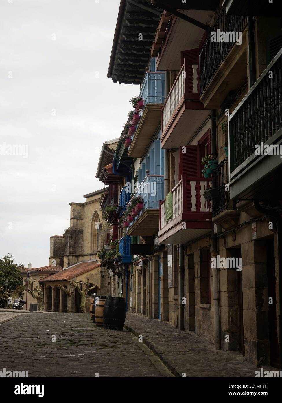 Old historical buildings facades in narrow cobblestone streets alley ...