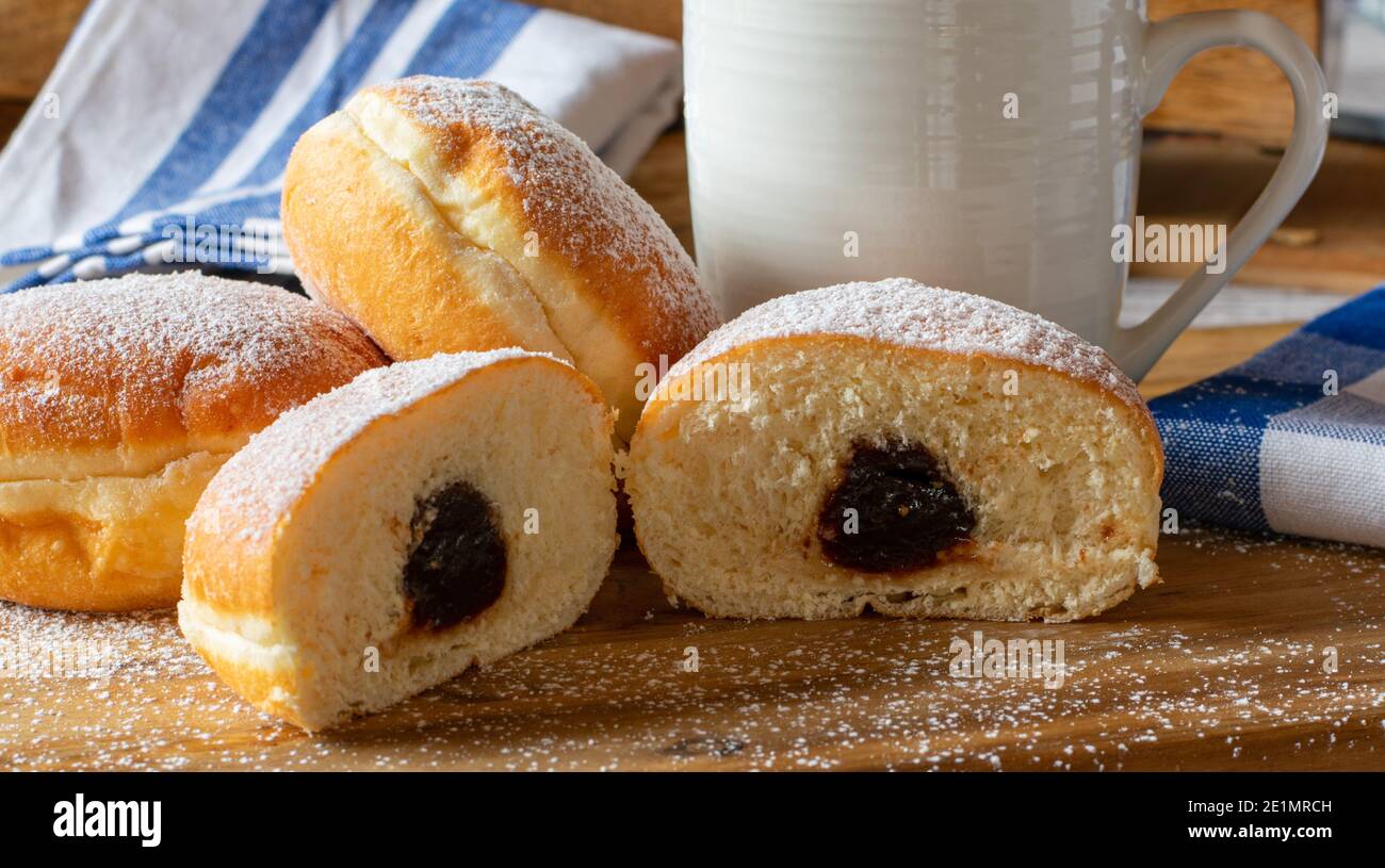 German donuts with plum compote. fried Berliner pancakes Stock Photo