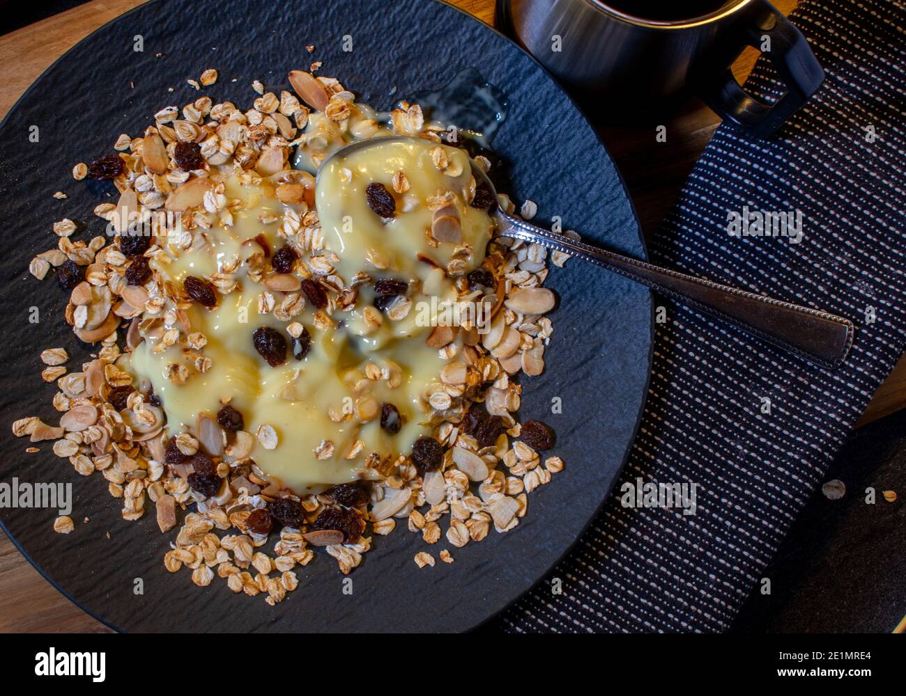 protein pudding with muesli on dark plate from above Stock Photo