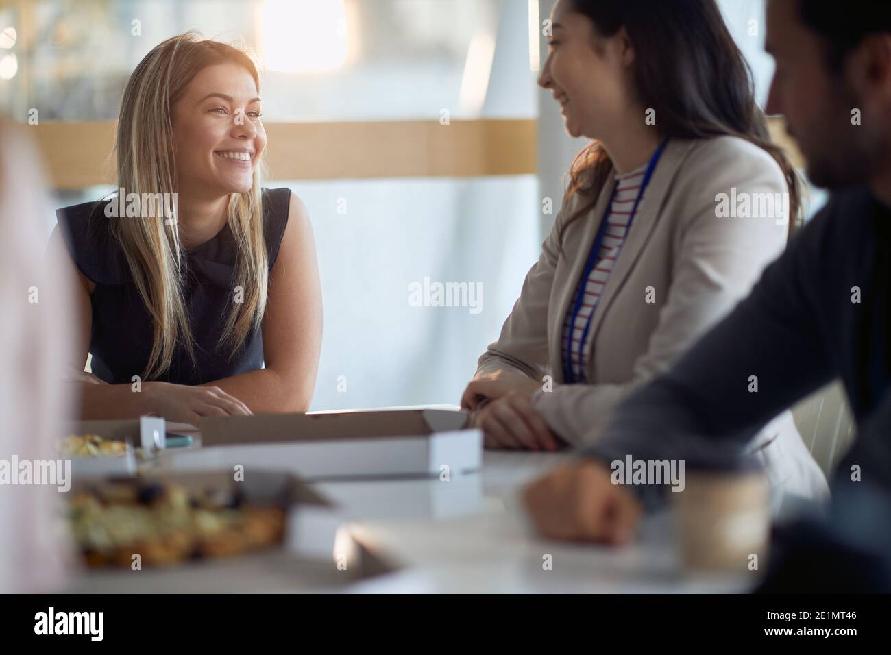 Employees chatting at lunch break in a pleasant atmosphere at company