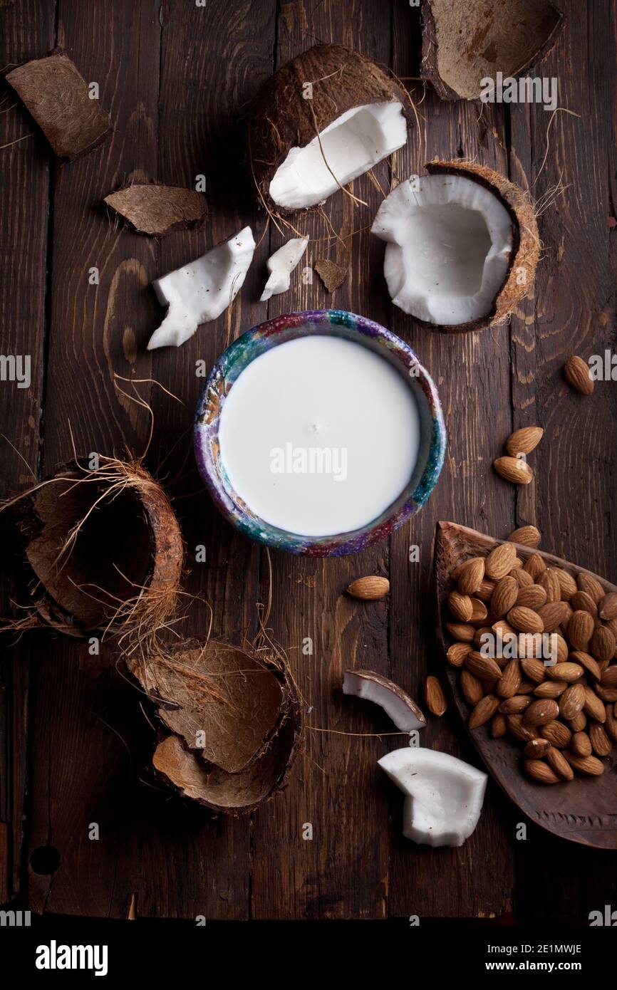 organic milk made of coconuts and almonds on rustic wooden table texture, nobody Stock Photo