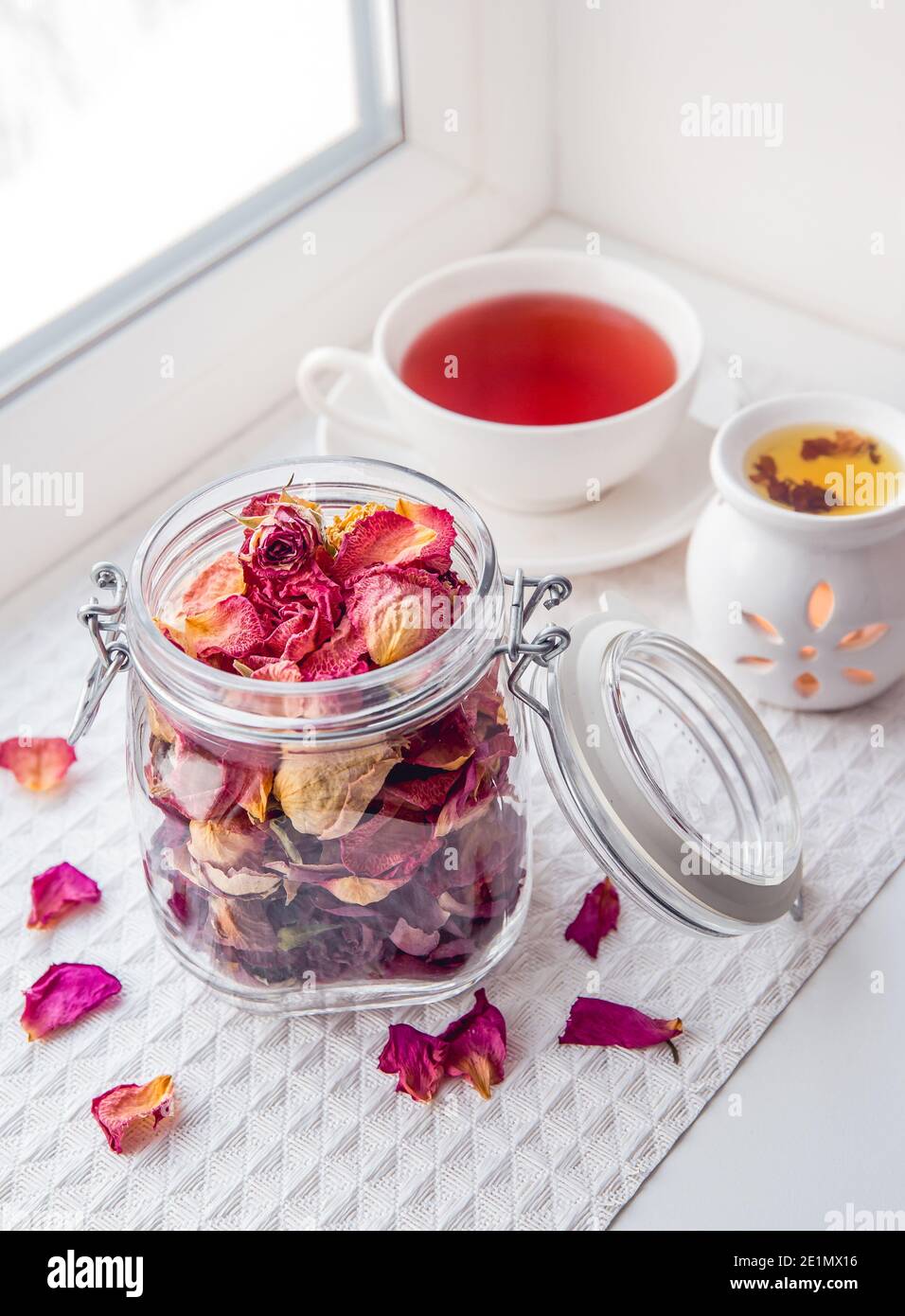 Using dry rose petals to make rose potpourri wich is great for home smell.  Great way to preserving flowers and memories. Mason jar lid open Stock  Photo - Alamy