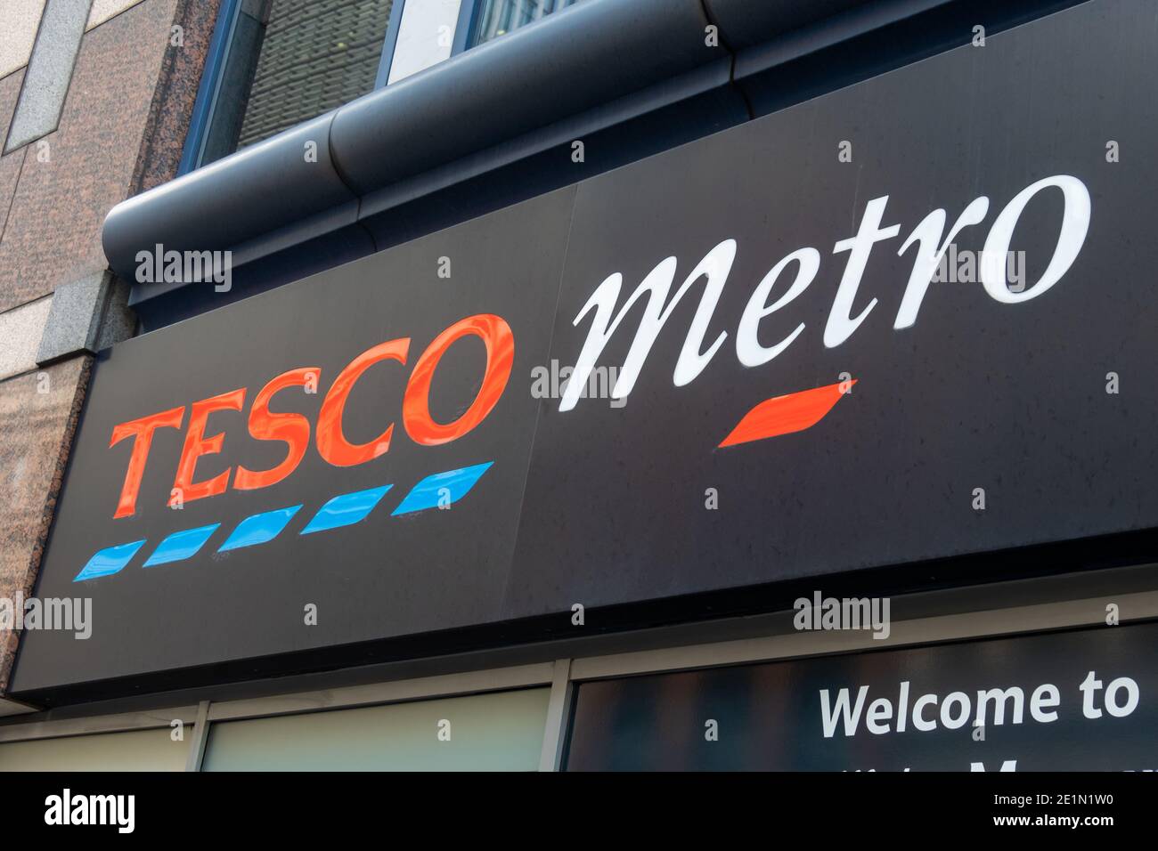 London: Tesco Metro shop sign, a convenience high street groceries store and major British supermarket chain Stock Photo