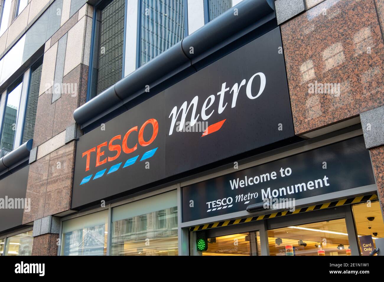 London: Tesco Metro shop sign, a convenience high street groceries store and major British supermarket chain Stock Photo