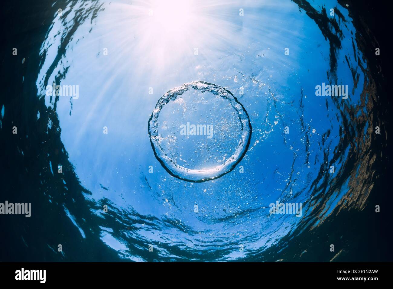 Ring bubble underwater and sun light in transparent ocean. Water texture. Stock Photo