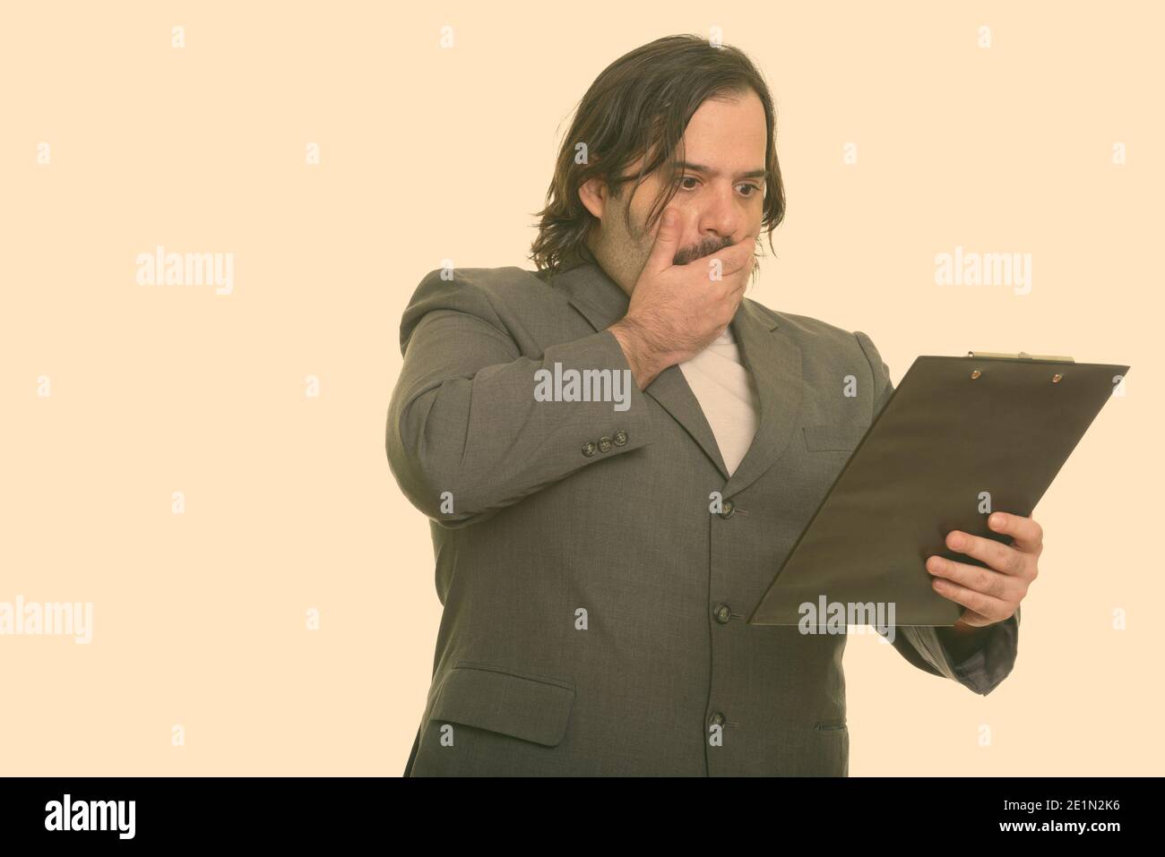 Fat Caucasian businessman looking shocked and covering mouth while ...