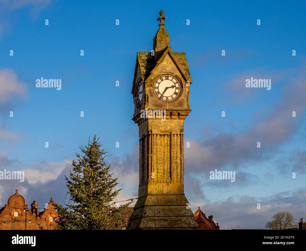 Thirsk clock tower with a Christmas tree in the background. Market
