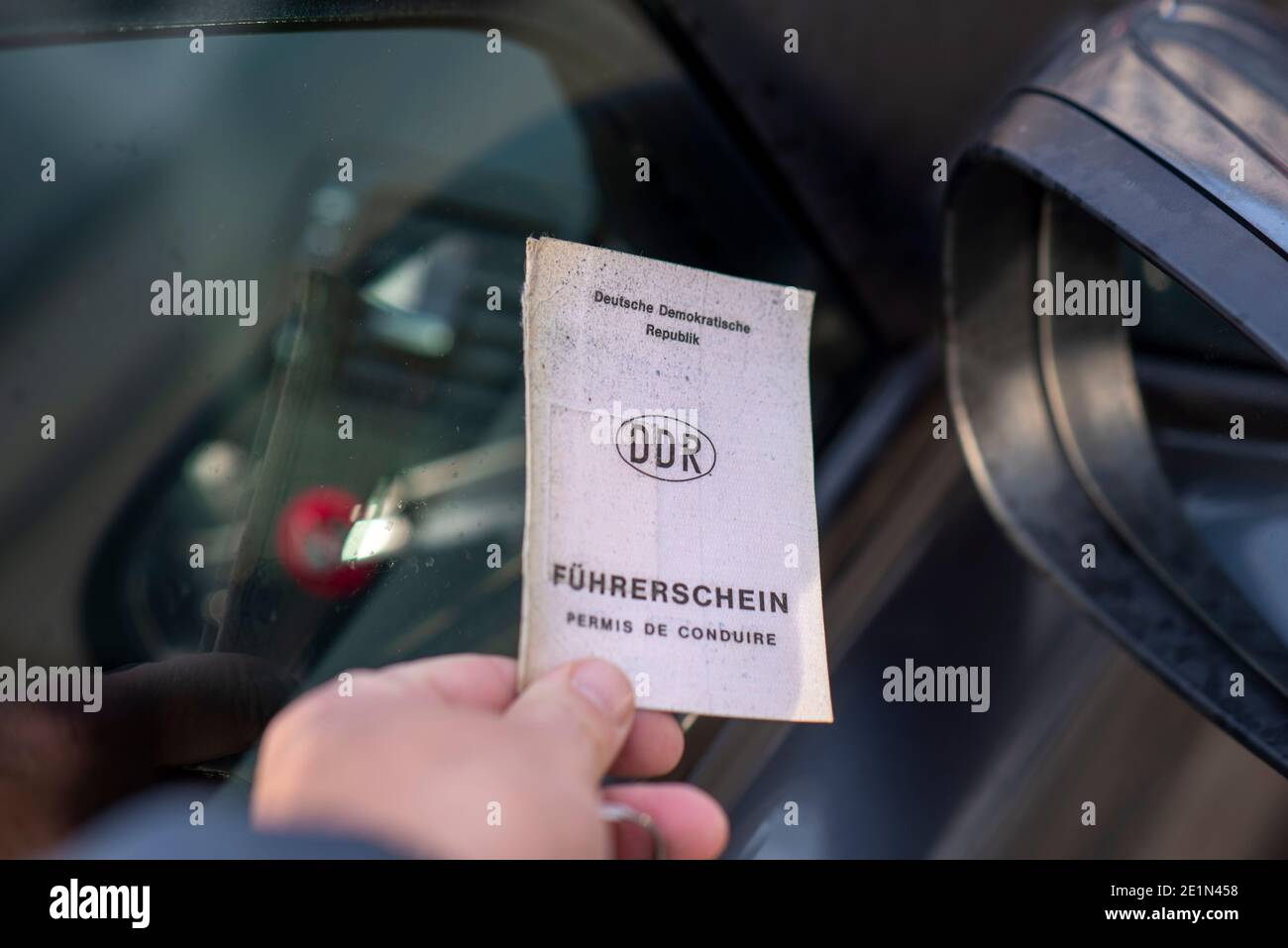 Magdeburg, Germany. 31st Dec, 2020. A woman holds a GDR driver's license in her hand. The GDR driving licences are still valid in the 31st year of German unification. However, they must be exchanged gradually, staggered according to birth cohorts. The last GDR driving licences will lose their validity in January 2033. Credit: Stephan Schulz/dpa-Zentralbild/ZB/dpa/Alamy Live News Stock Photo