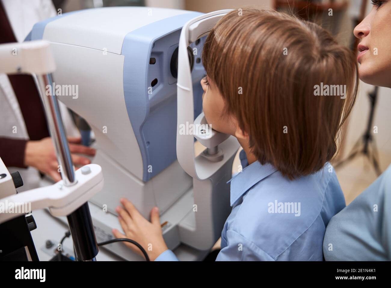 Boy putting his head on a chin rest Stock Photo Alamy