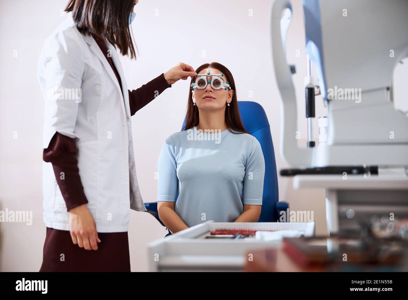 Eye physician making a horizontal adjustment of a trial frame Stock Photo