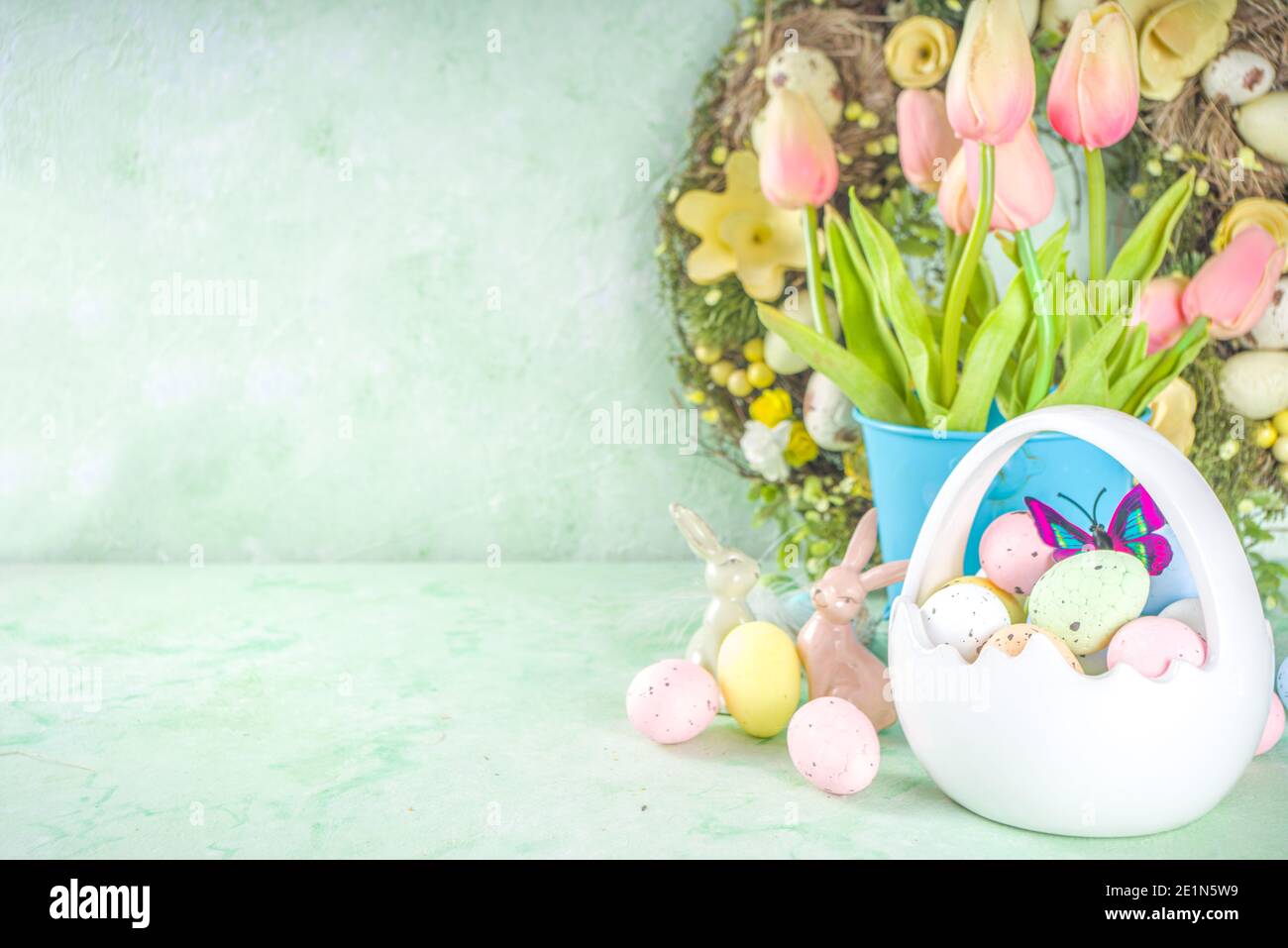 Happy Easter concept with easter eggs in basket and spring flowers ...