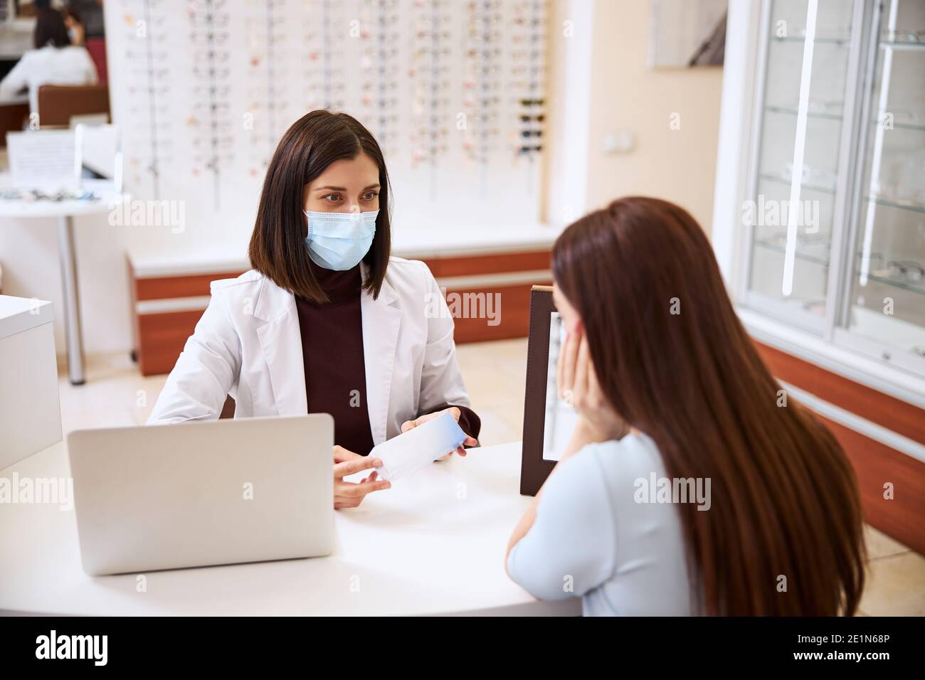 Determined physician encouraging her customer for buying a package Stock Photo