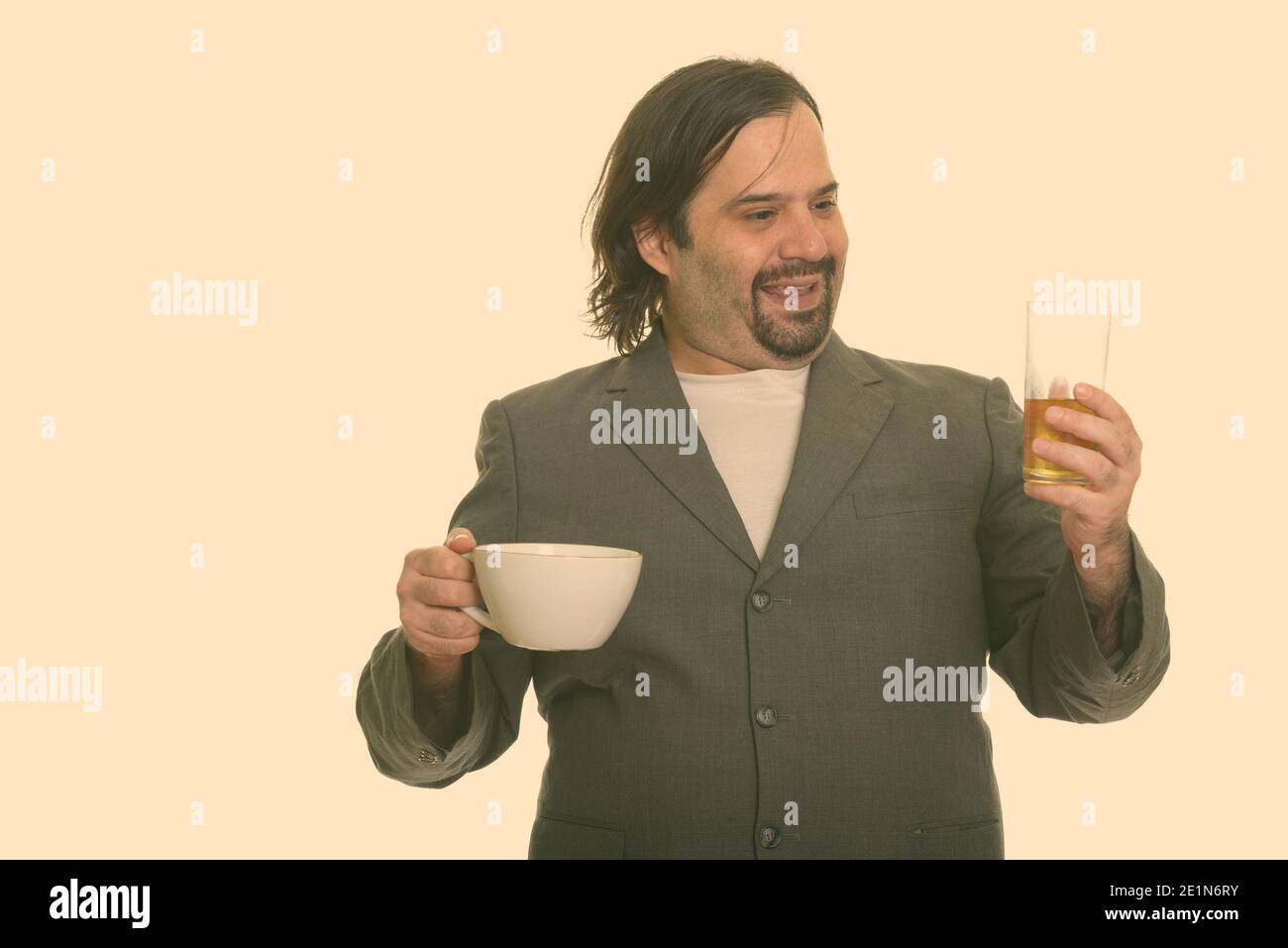 Happy fat Caucasian businessman smiling and choosing beer over coffee Stock Photo