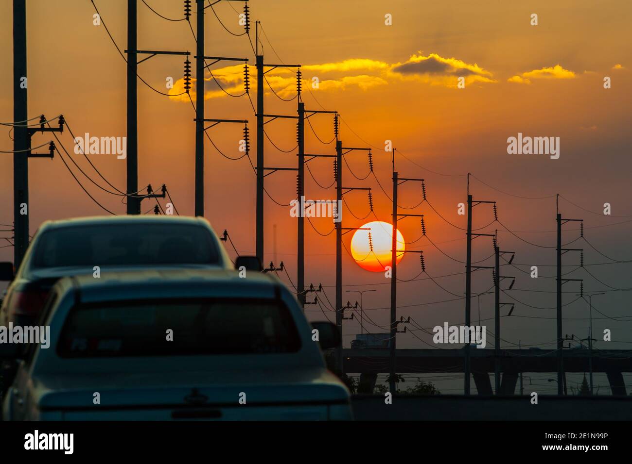 Electricity post in front of sunset background Stock Photo - Alamy