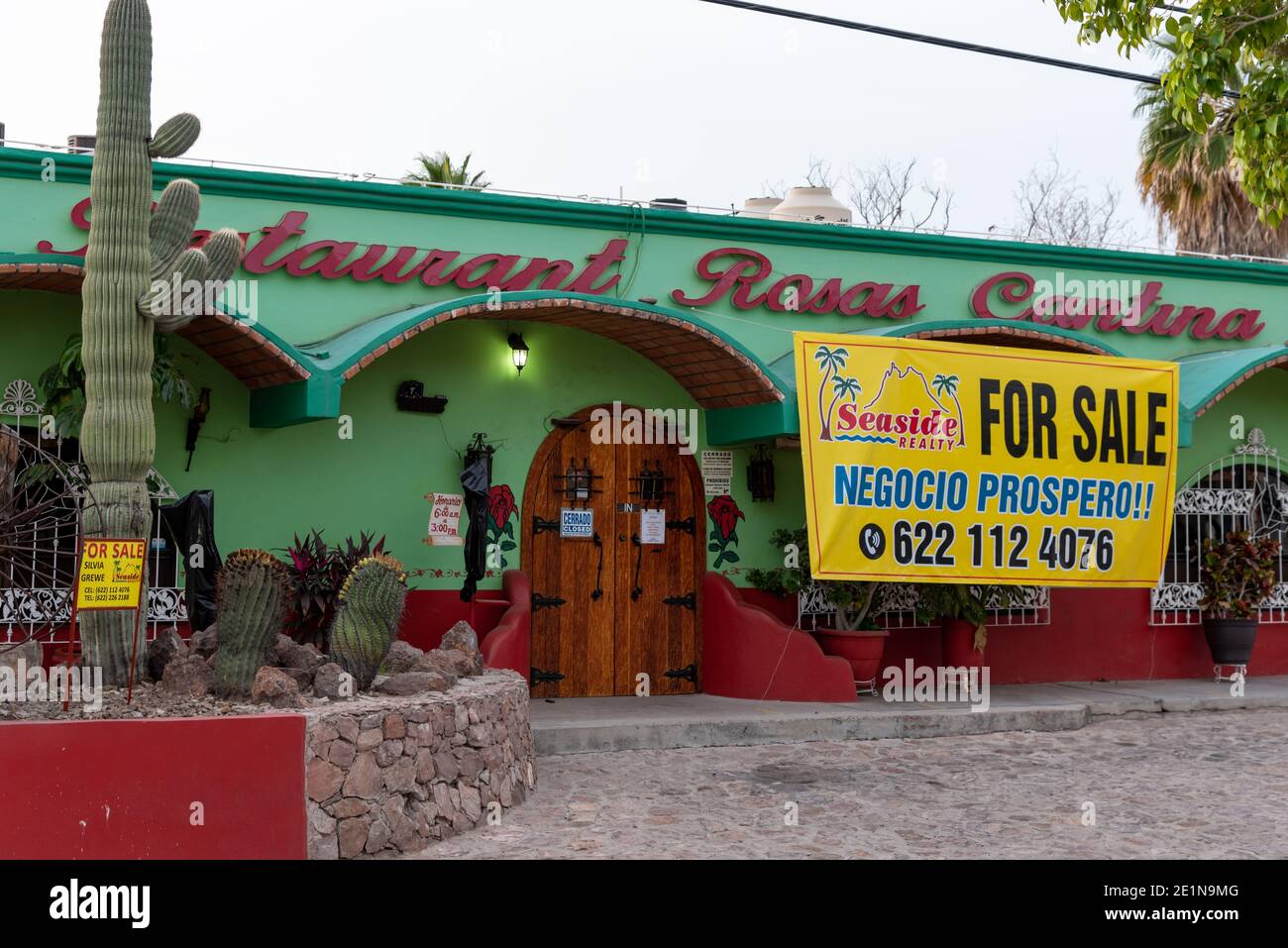 A large yellow for sale sign hangs across the front of Rosa’s Cantina, a popular restaurant in San Carlos, Sonora, Mexico. Stock Photo