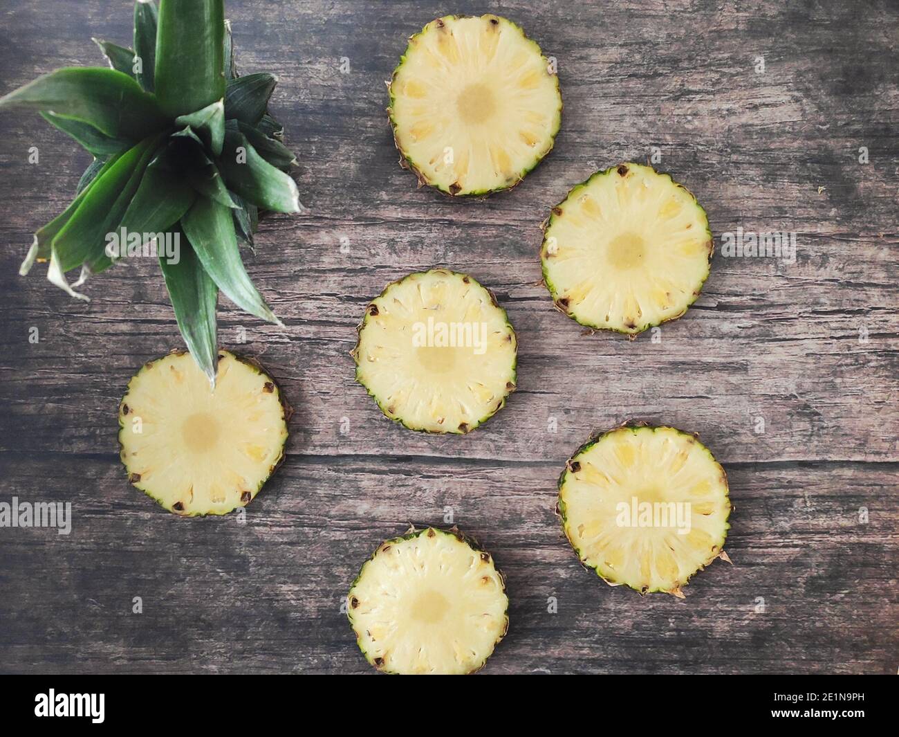 Sliced and chopped pineapple on a dark background Stock Photo