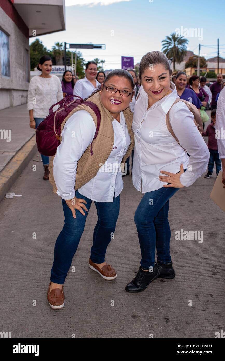 In Guaymas, Sonora, Mexico, two female protesters pose for a photo during a women’s march against violence. Stock Photo