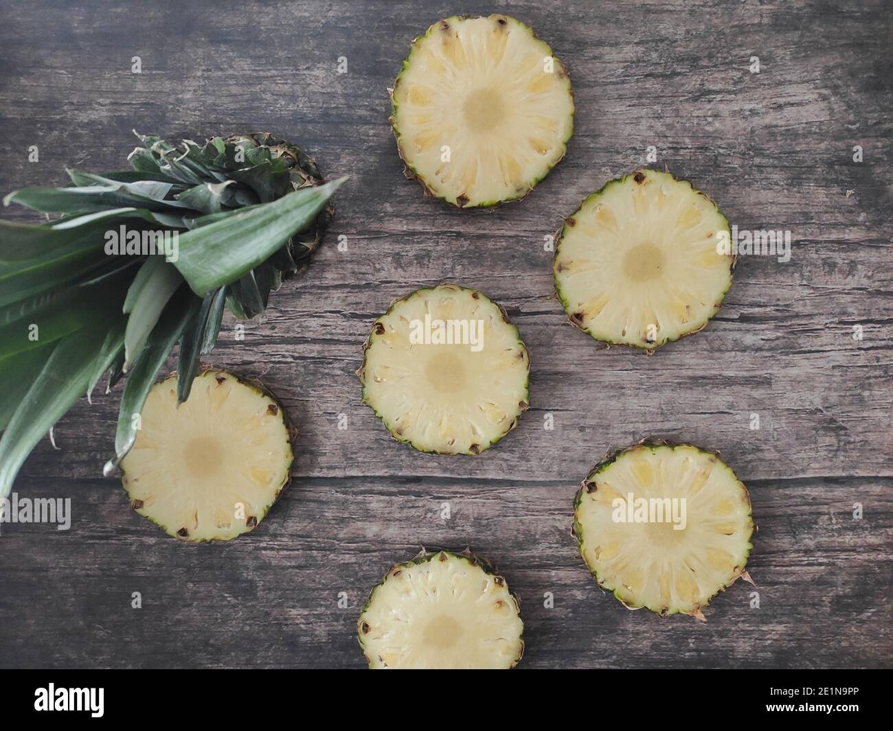 Sliced and chopped pineapple on a dark background Stock Photo
