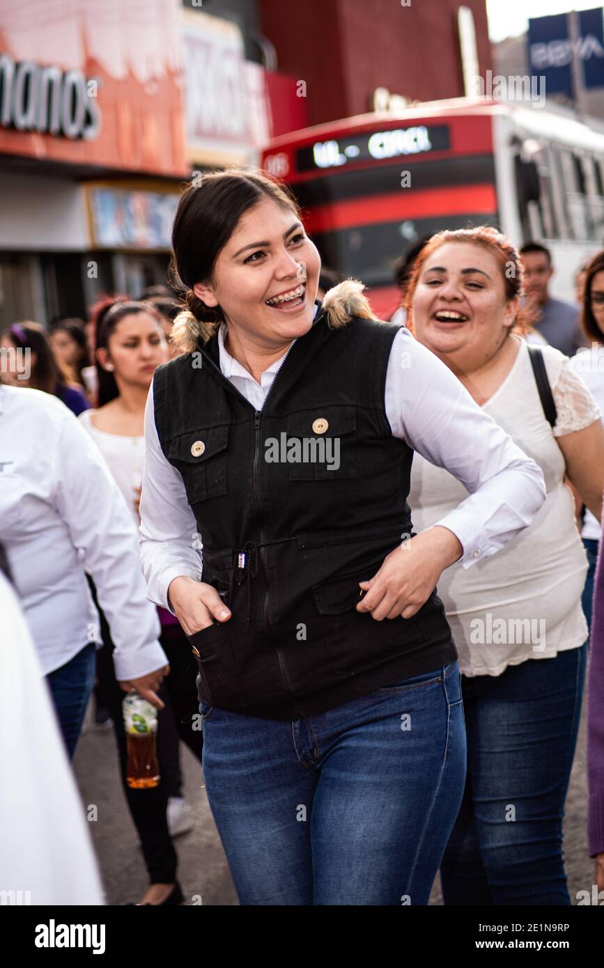 Young smiling women march in the streets of Guaymas, Sonora, Mexico, protesting violence against women. Stock Photo