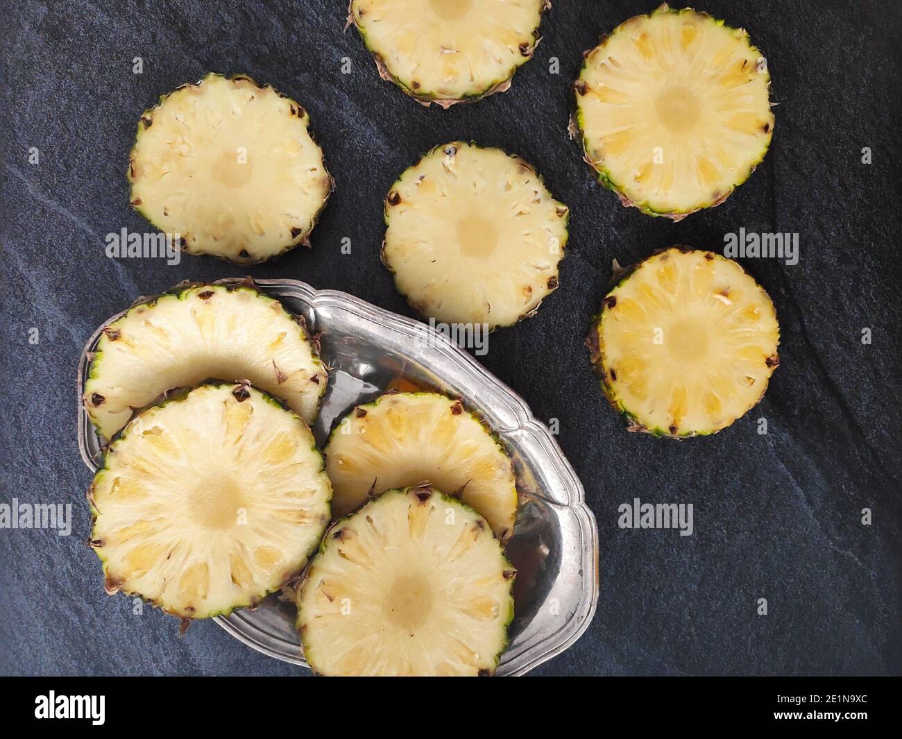 Sliced and chopped pineapple on a dark background Stock Photo