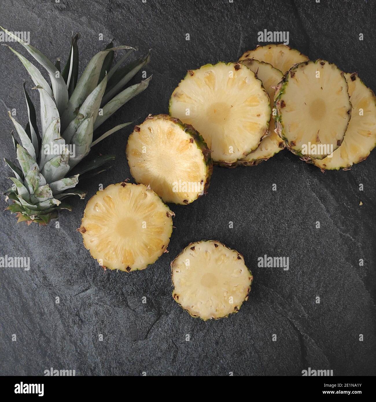 Sliced and chopped pineapple on a dark background Stock Photo