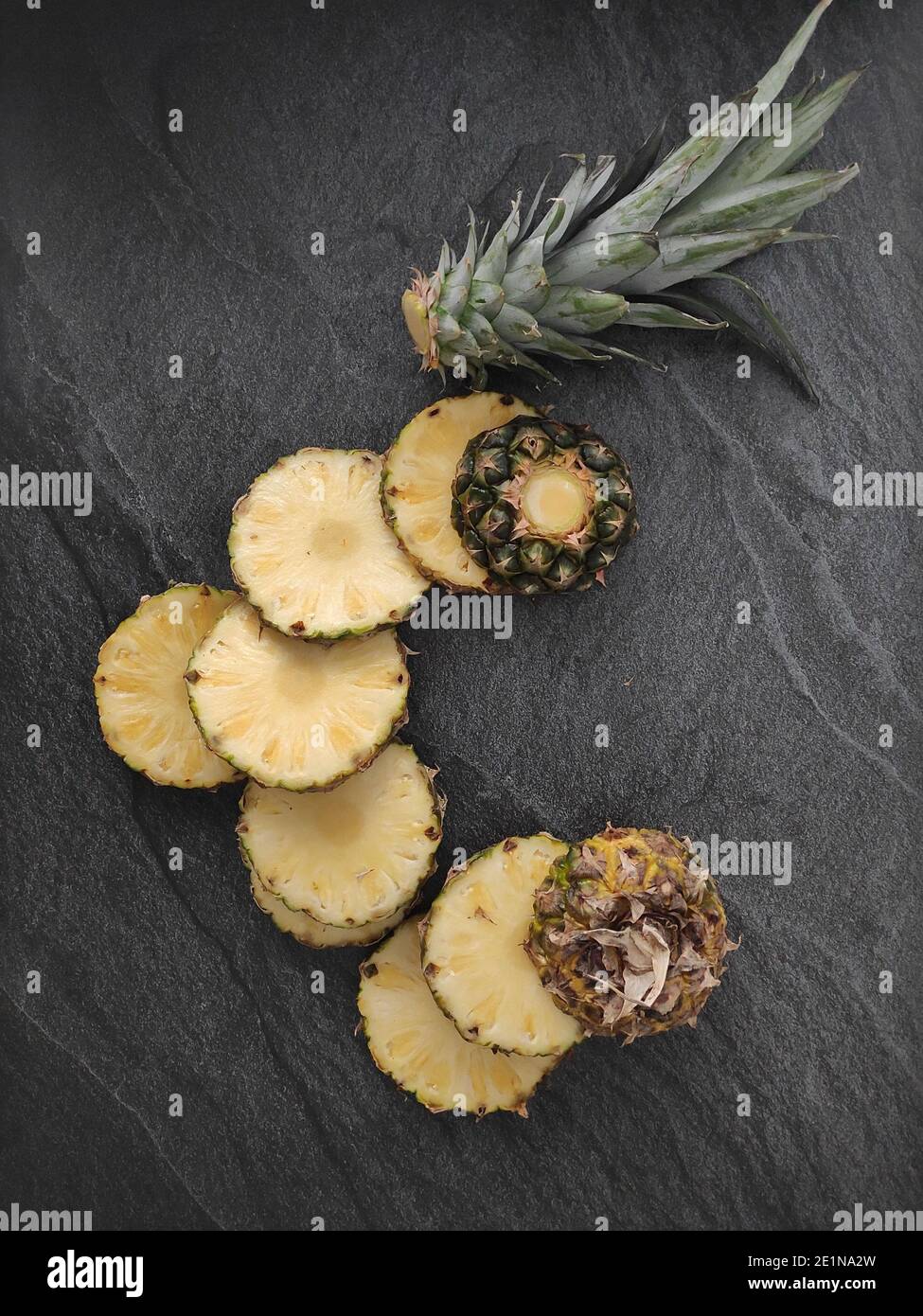 Sliced and chopped pineapple on a dark background Stock Photo