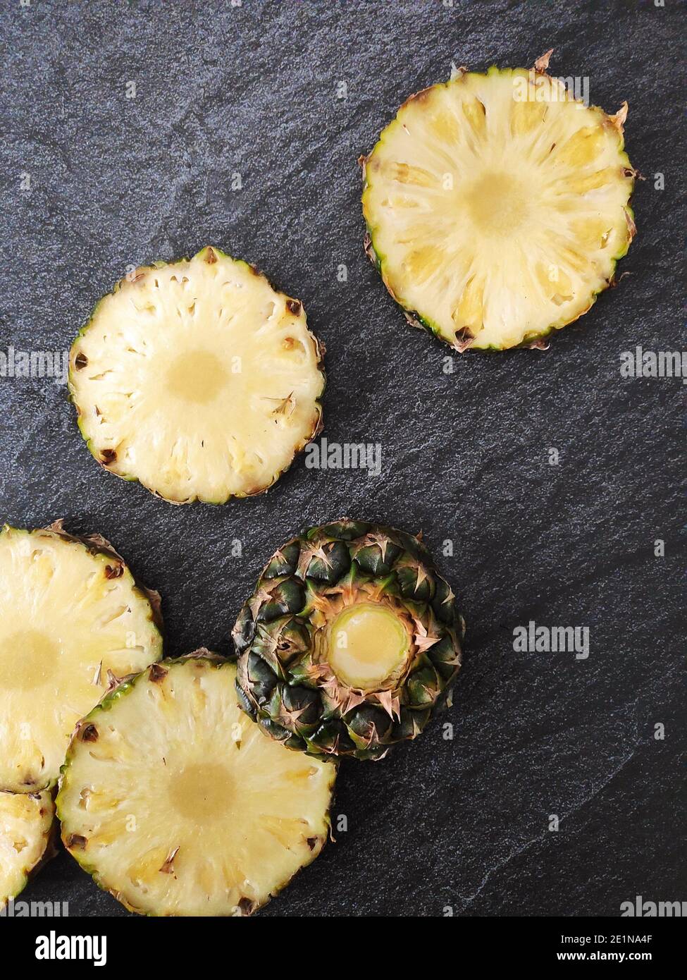 Sliced and chopped pineapple on a dark background Stock Photo