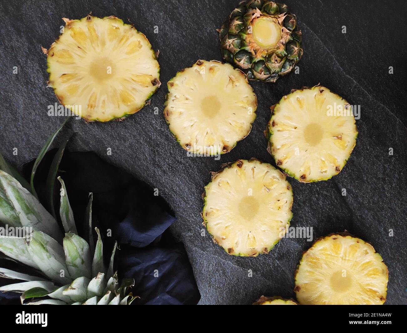 Sliced and chopped pineapple on a dark background Stock Photo