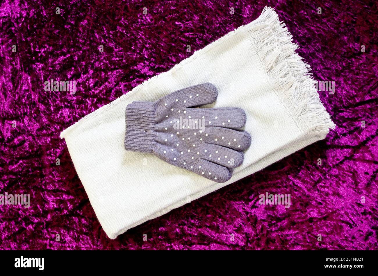 Women's or Ladies Fabric White Scarf and Sequin Grey or Gray Pair of Gloves Stock Photo