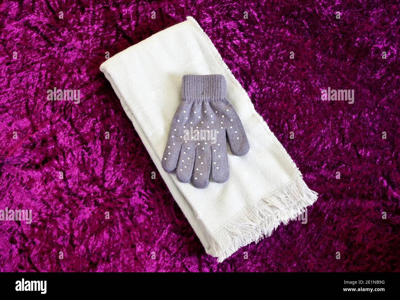 Women's or Ladies Fabric White Scarf and Sequin Grey or Gray Pair of Gloves Stock Photo