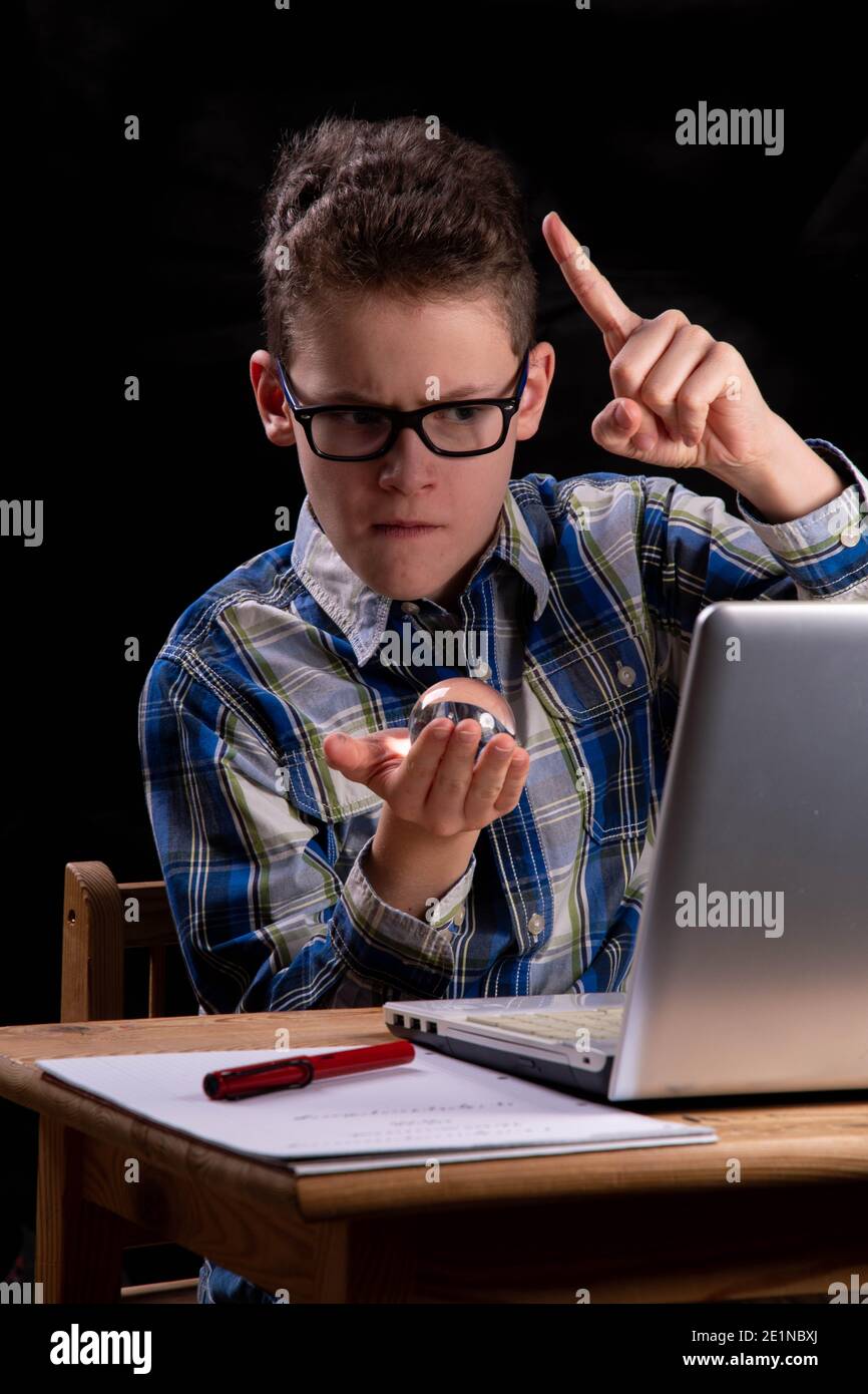 Boy with glass ball on PC scolds Stock Photo