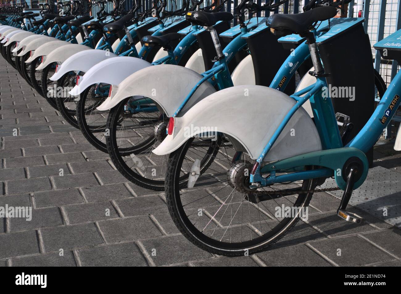 A group of many parked bicycle's in a profiled view. Stock Photo