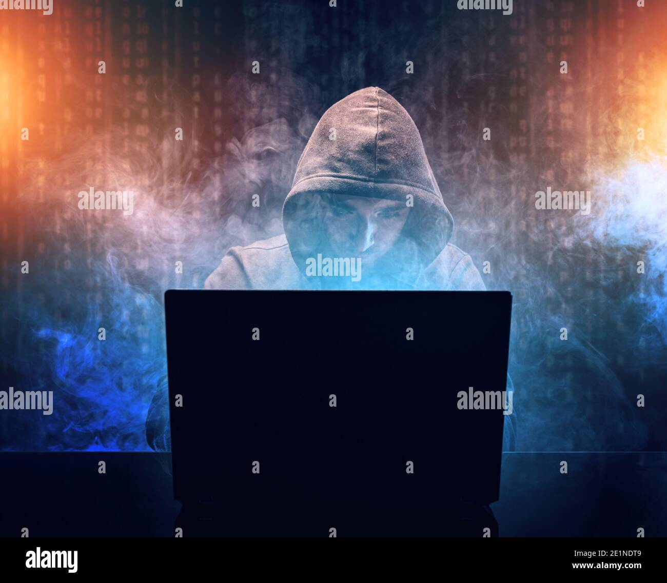 Hacker in front of his laptop. Hooded hacker cyber war concept Stock Photo