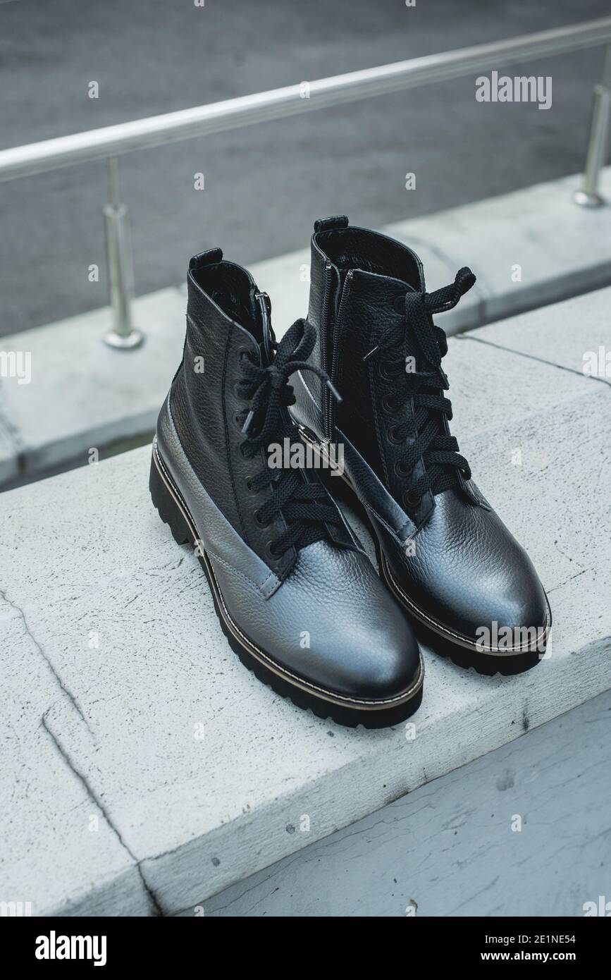 High women's or unisex shoes. Pair of boots with shoe laces. Modern youth  fashion of women's casual footwear. Dark grey glossy leather shoes Stock  Photo - Alamy