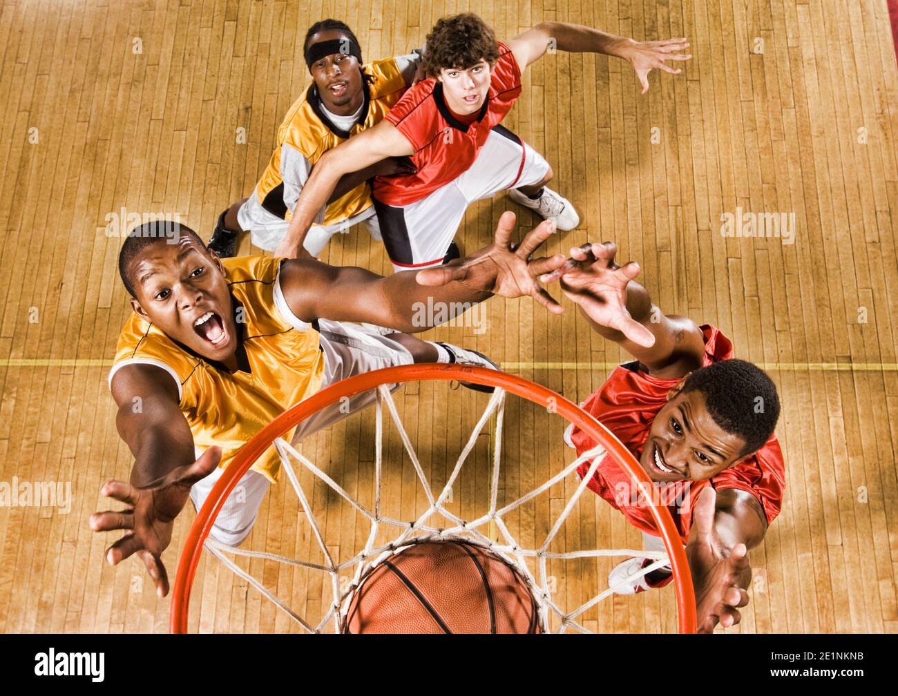High angle shot of basketball player dunking basketball in hoop Stock
