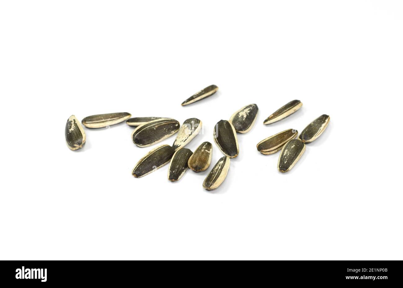 Unpeeled Sunflower seeds isolated on white background Stock Photo - Alamy