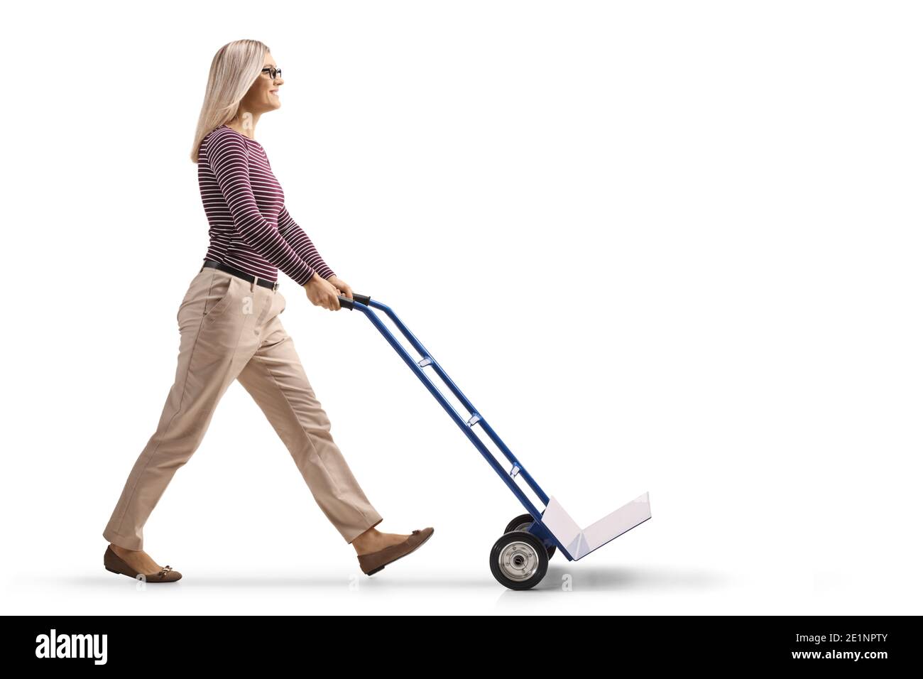 Full length profile shot of a young woman pushing an empty hand-truck isolated on white background Stock Photo