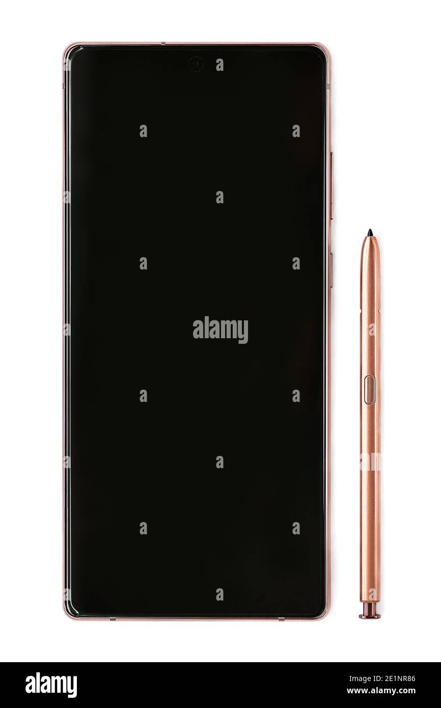 Surgut, Khanty-Mansiyskiy avtonomnyy okrug, Russia - December 27, 2020: Samsung Galaxy Note 20 smartphone bronze. A black display of a mobile phone next to a lying stylus. Stock Photo