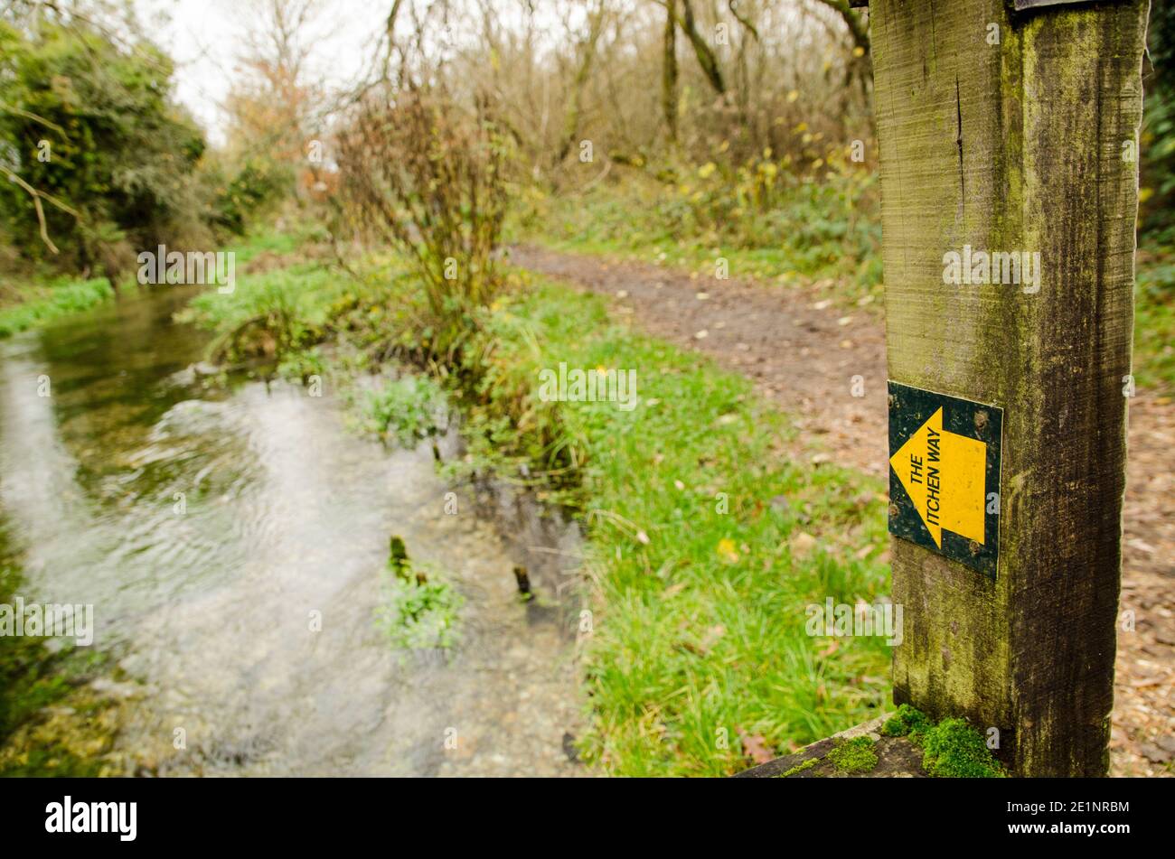 Marker arrow showing the route of the Itchen Way alongside the River Itchen in the Hampshire village of Itchen Stoke on a cloudy autumn day. Stock Photo