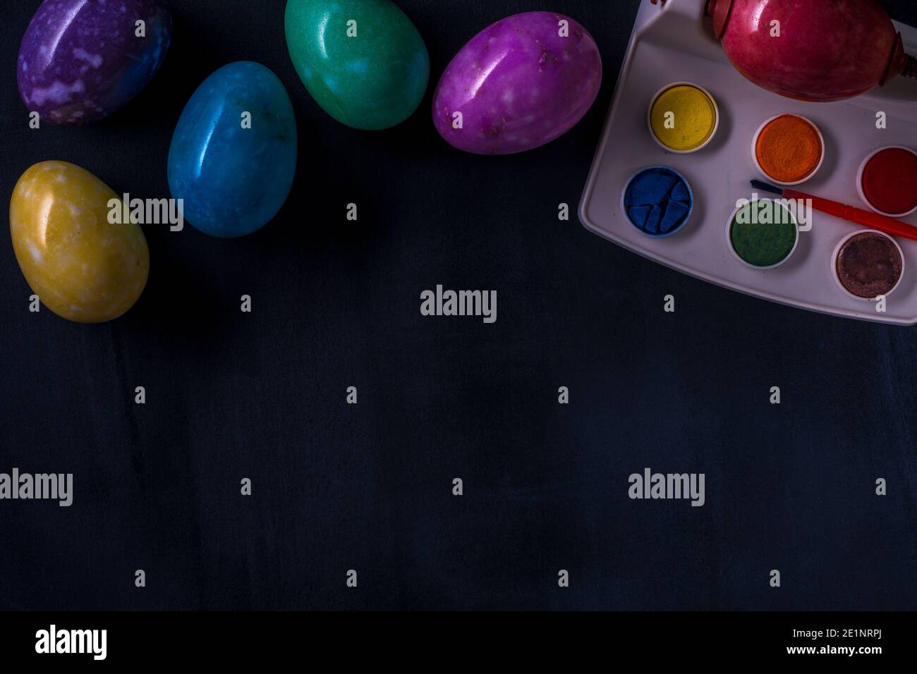 Easter multicolored eggs from stones on a dark background. Stock Photo