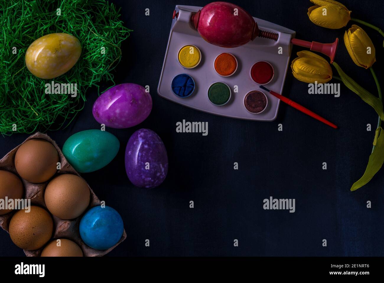 Easter multicolored eggs from stones on a dark background. Stock Photo