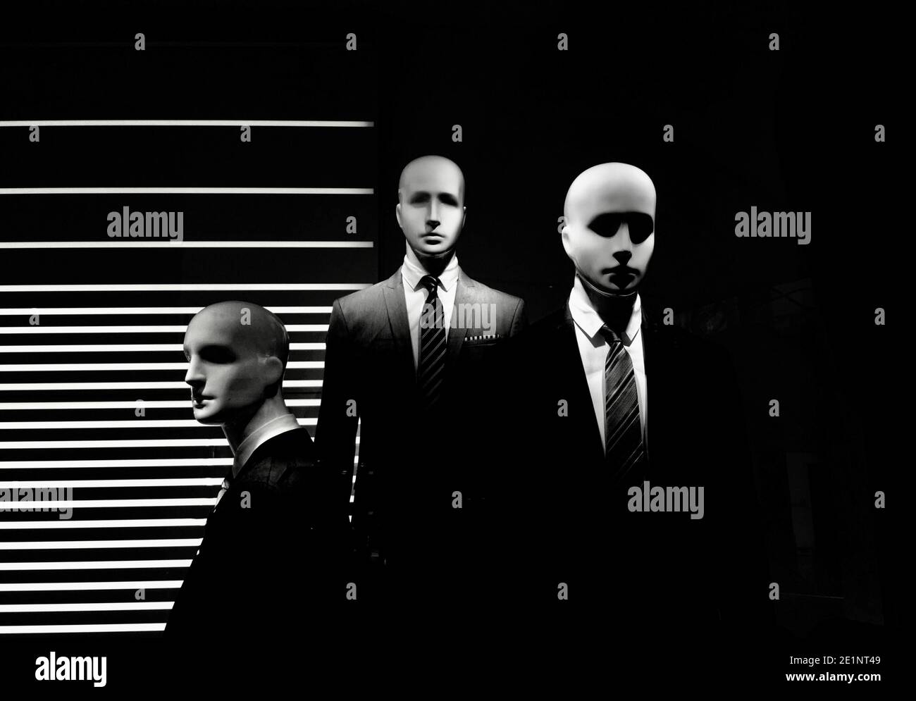 men models in black dress suit at the showcase isolated on black background Stock Photo