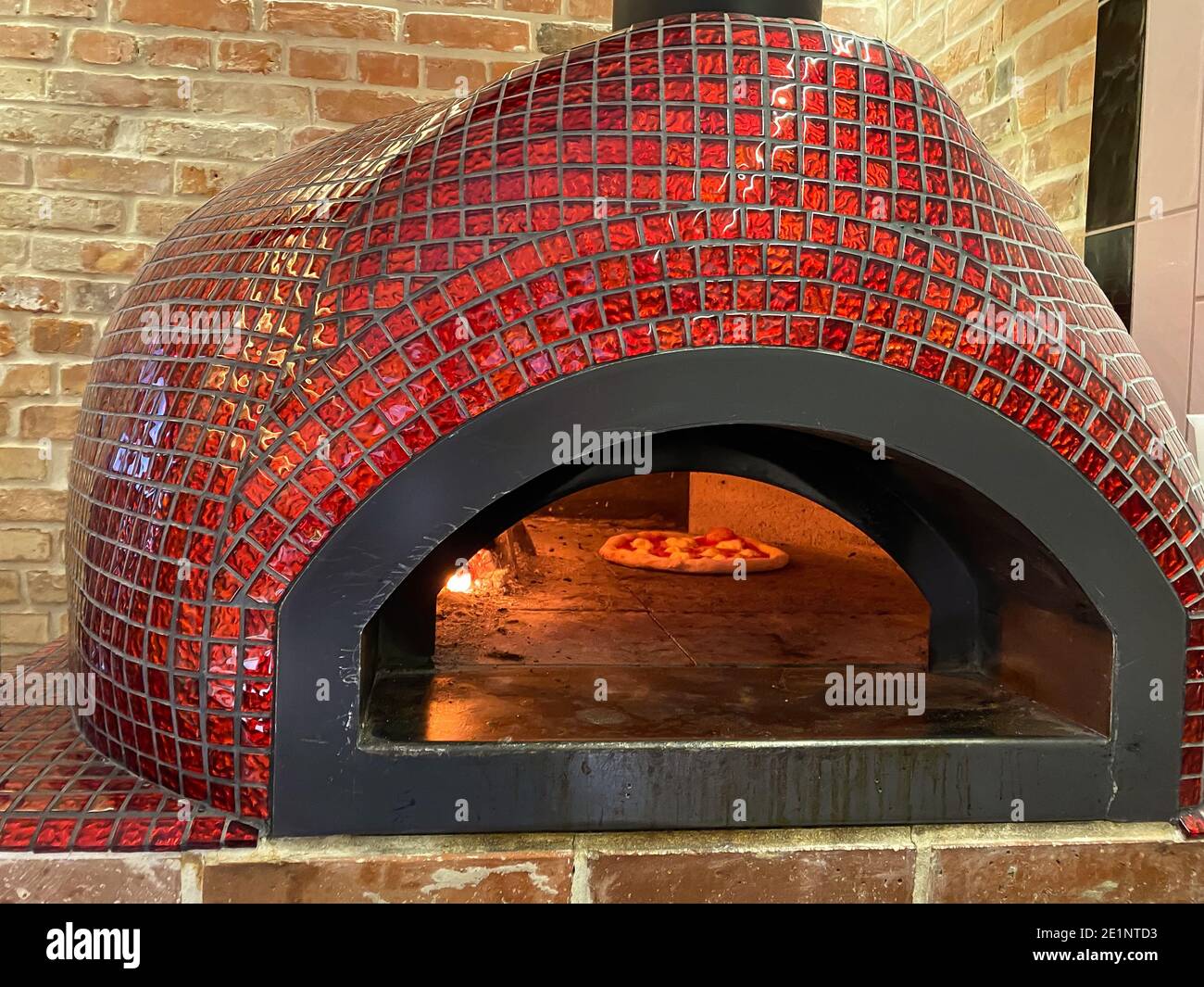 Baking oven, fireplace in the middle next to rising dough pizza, Italian traditional dish Stock Photo