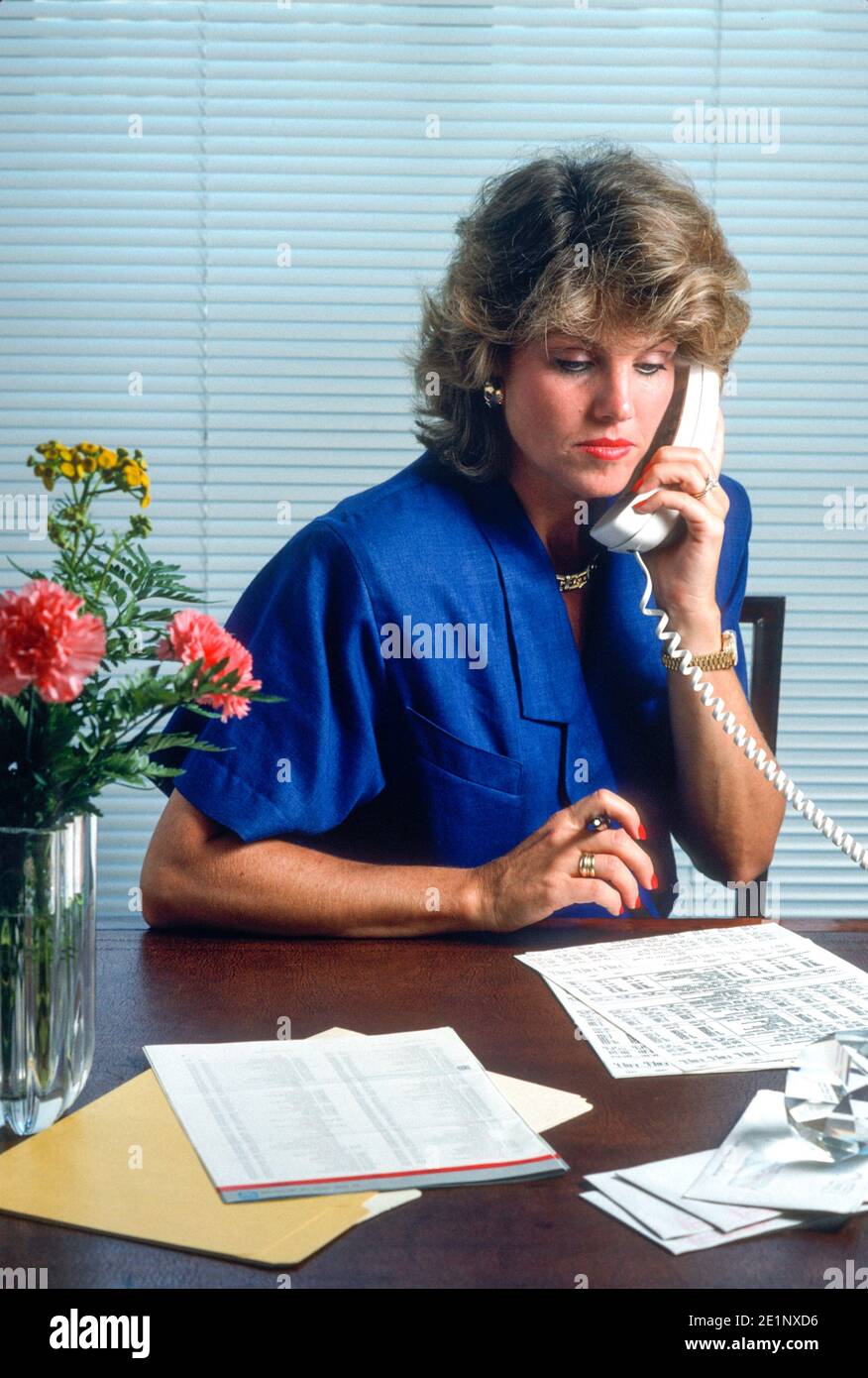 No Nonsense Female Executive Works on her spread sheets, USA, 1989 Stock Photo