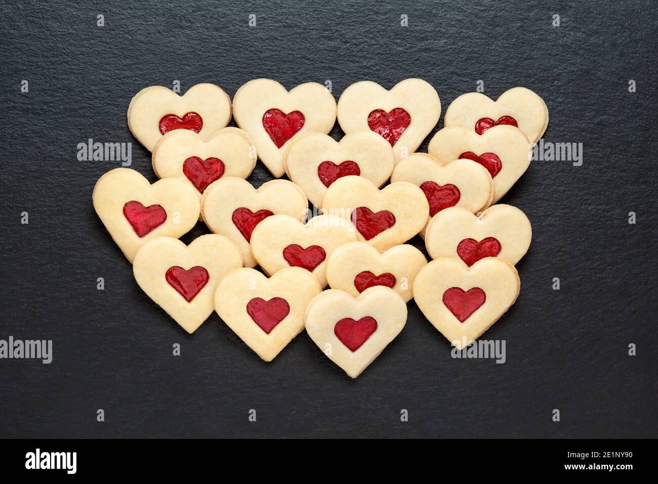 christmas cookies hearts with strawberry jam on slate table Stock Photo